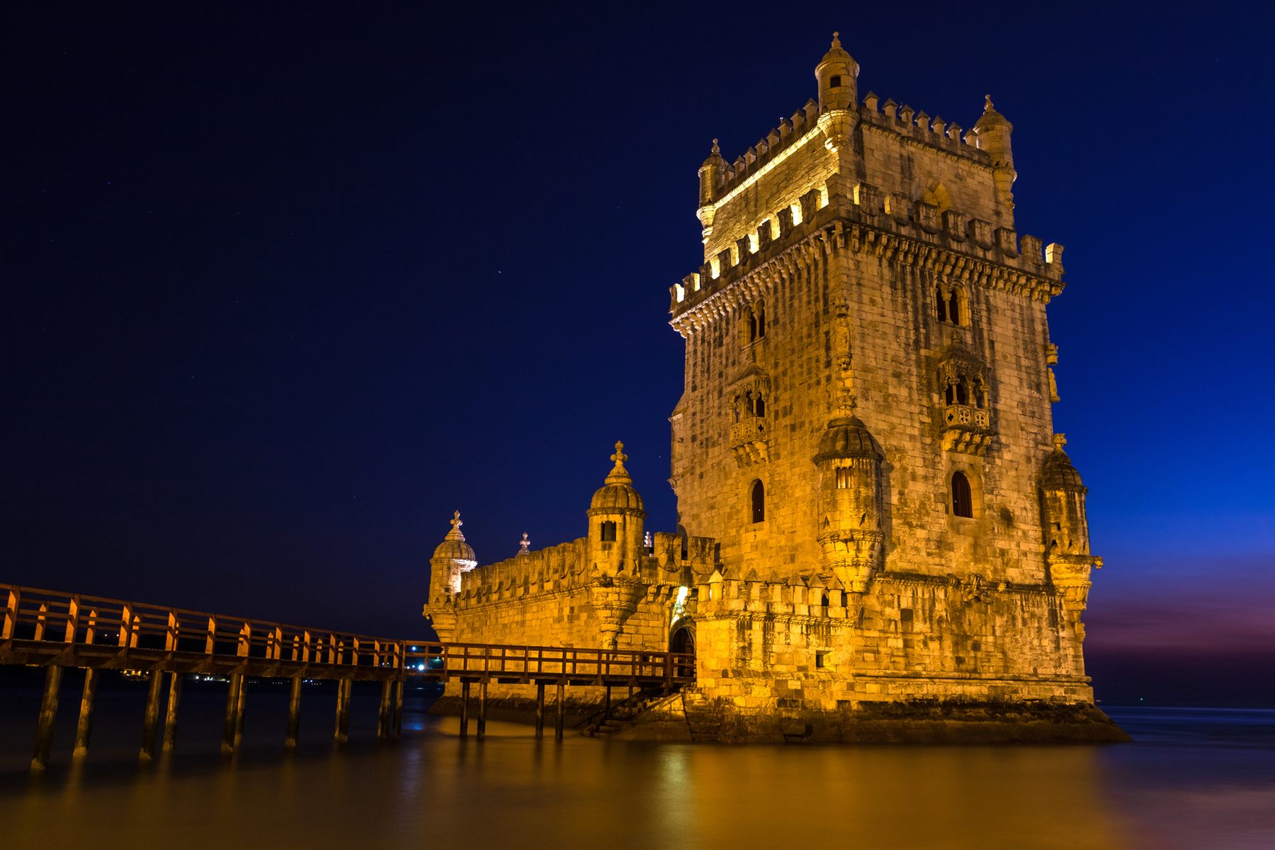 The floodlit Belém Tower on the Tagus River in Lisbon, Portugal, at dusk